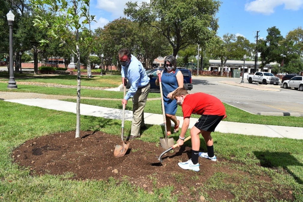 Dr. Evans and family planting a tree
