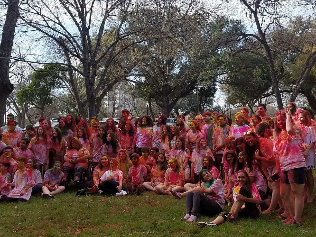 holi- group of students surrounded by trees
