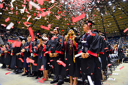 UIW students celebrating commencement with confetti