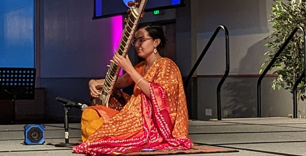 Woman playing musical instrument at the Diwali event