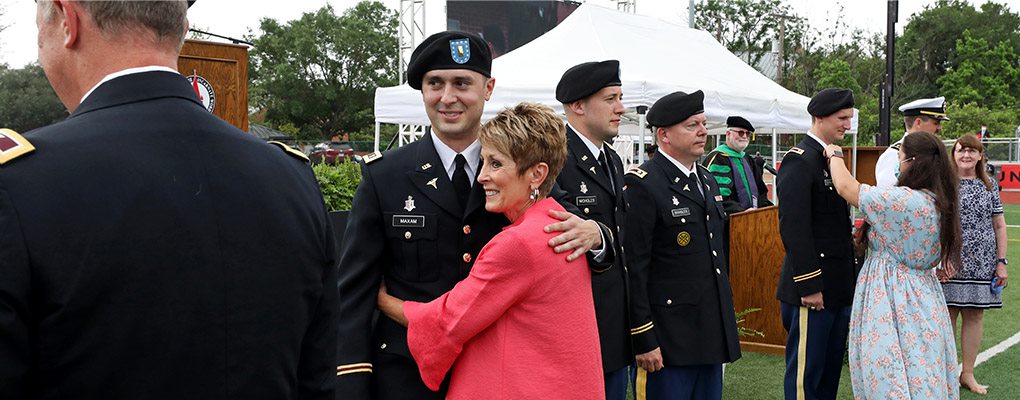 A military graduate embracing a parent