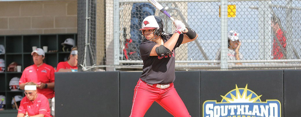 Mikaela Flores holds a softball bat and prepares to swing