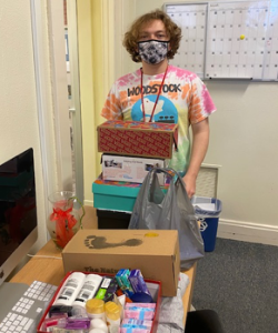 A student holding shoeboxes