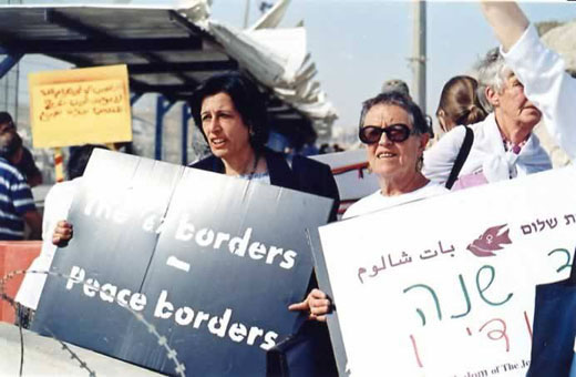 Women standing at a checkpoint between Israel and the West Bank