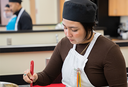 Student cooking in nutrition class
