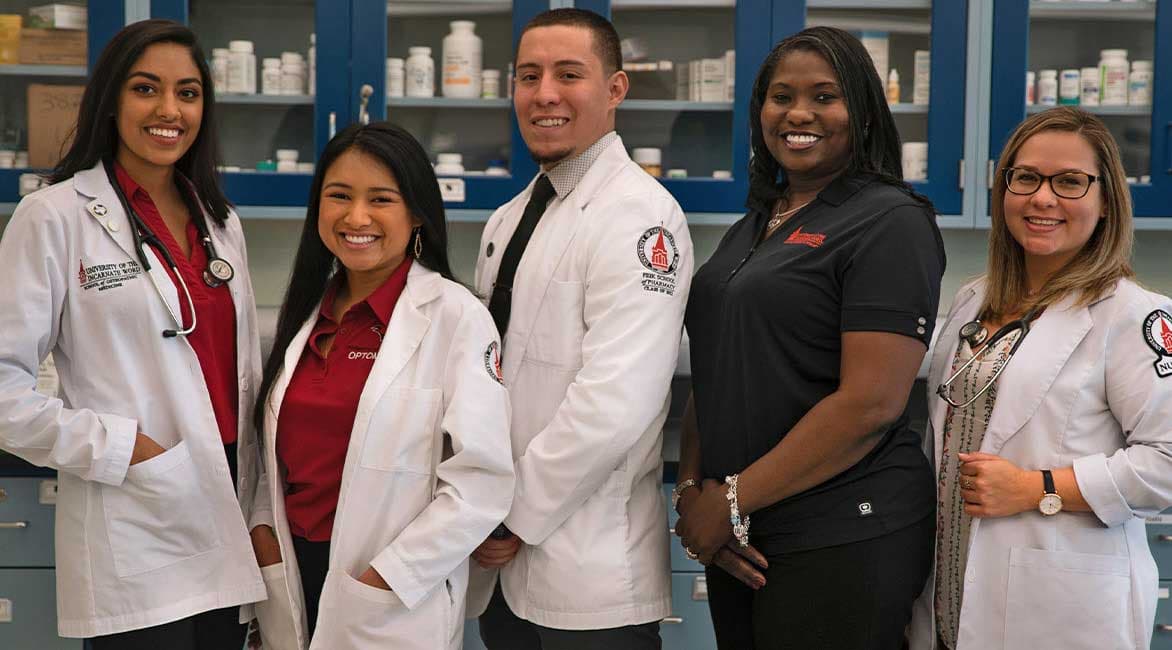 UIW health professions students smiling and standing for photo