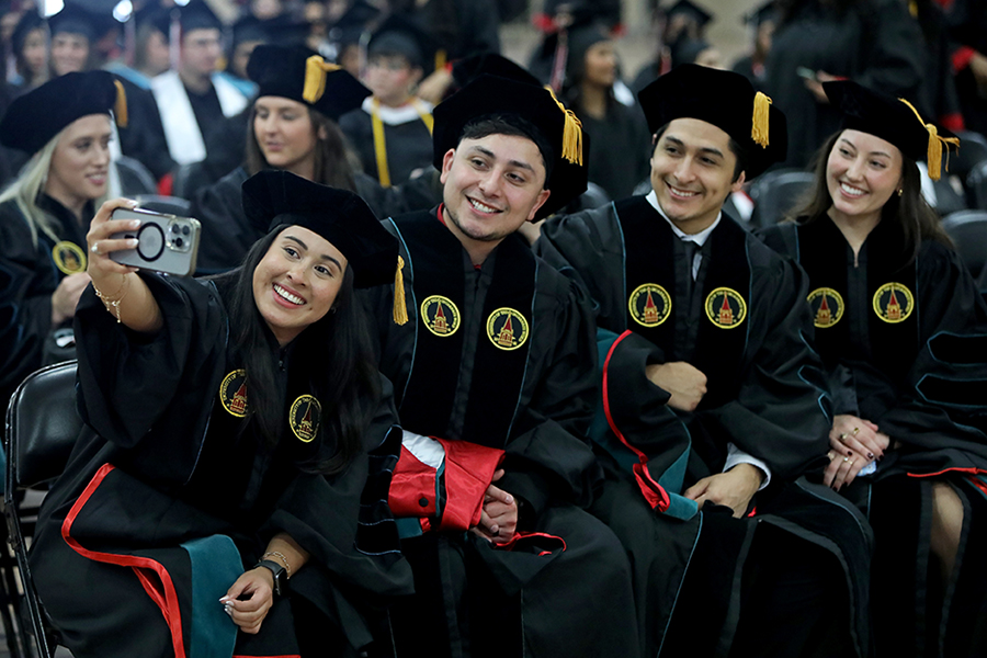 Students taking a selfie at graduation
