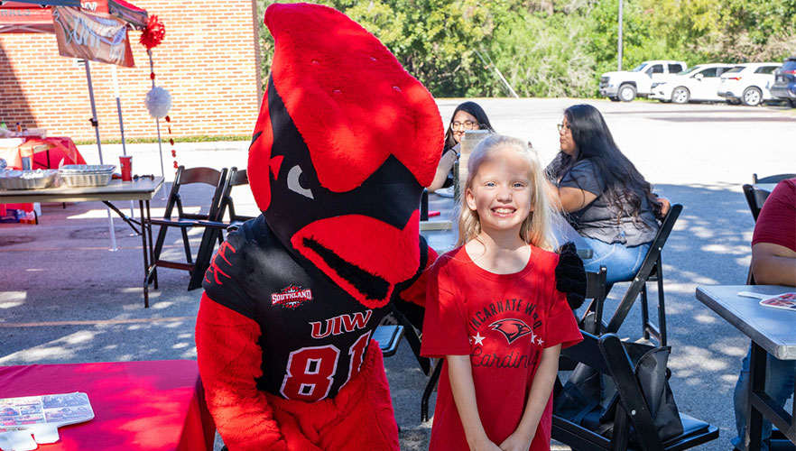 Red mascot with child