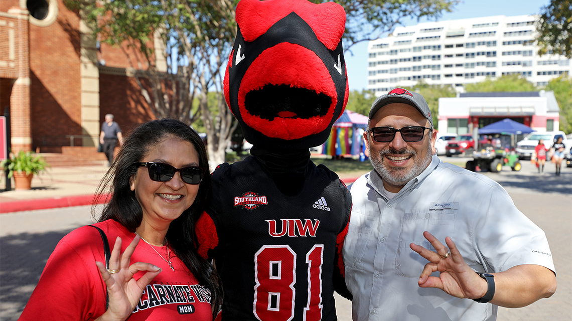 two parents with Red the Cardinal