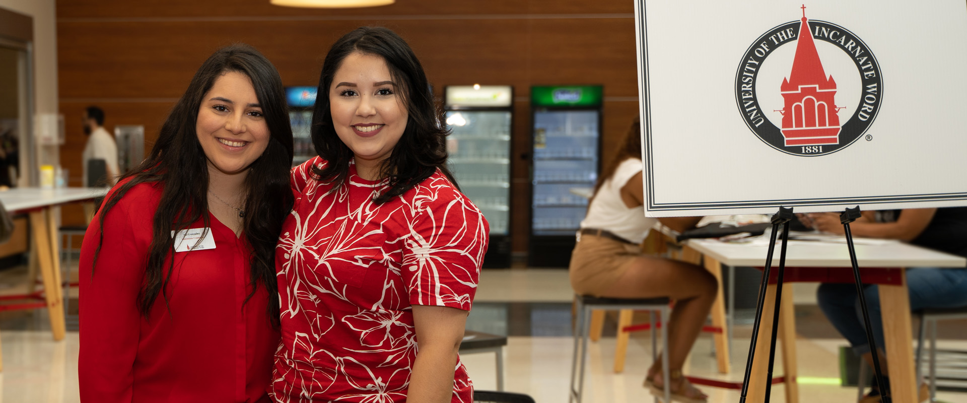 Two female UIW admissions counselors at an admissions event.