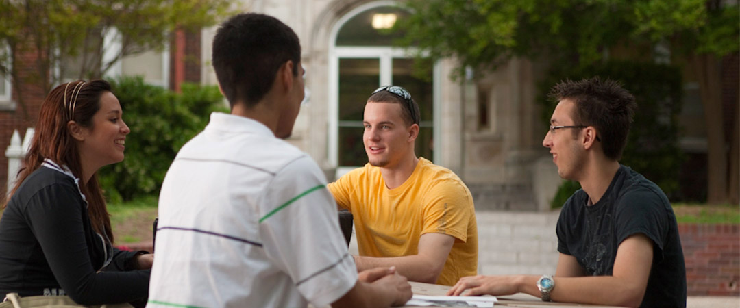 Four students talking outside