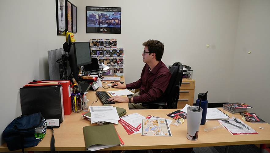 Dillon at his desk in the Welcome Center