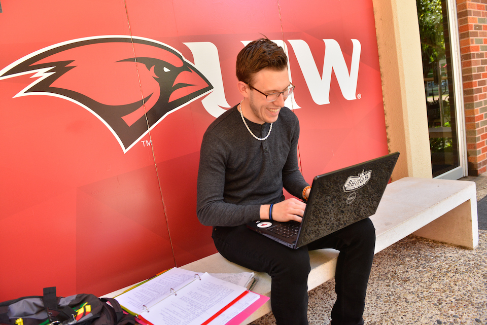 An alumnus updating their contact information on campus