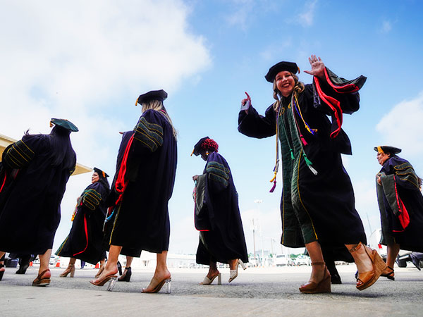 Graduate at commencement checking in