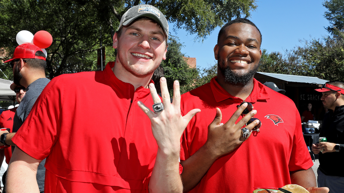 Two UIW football alumni show off their conference championship rings at Homecoming