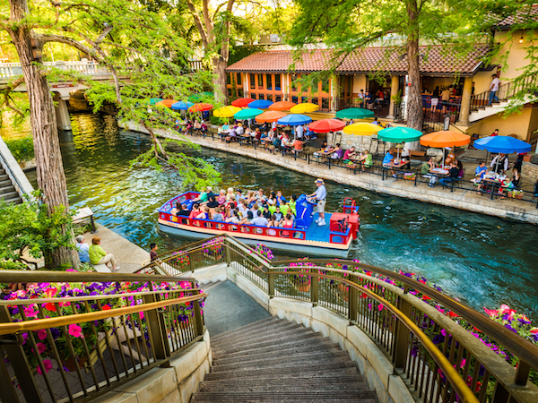 A barge floating on the riverwalk in San Antonio, Texas