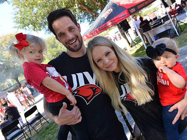 Family at tailgate smiling, husband, wife and children