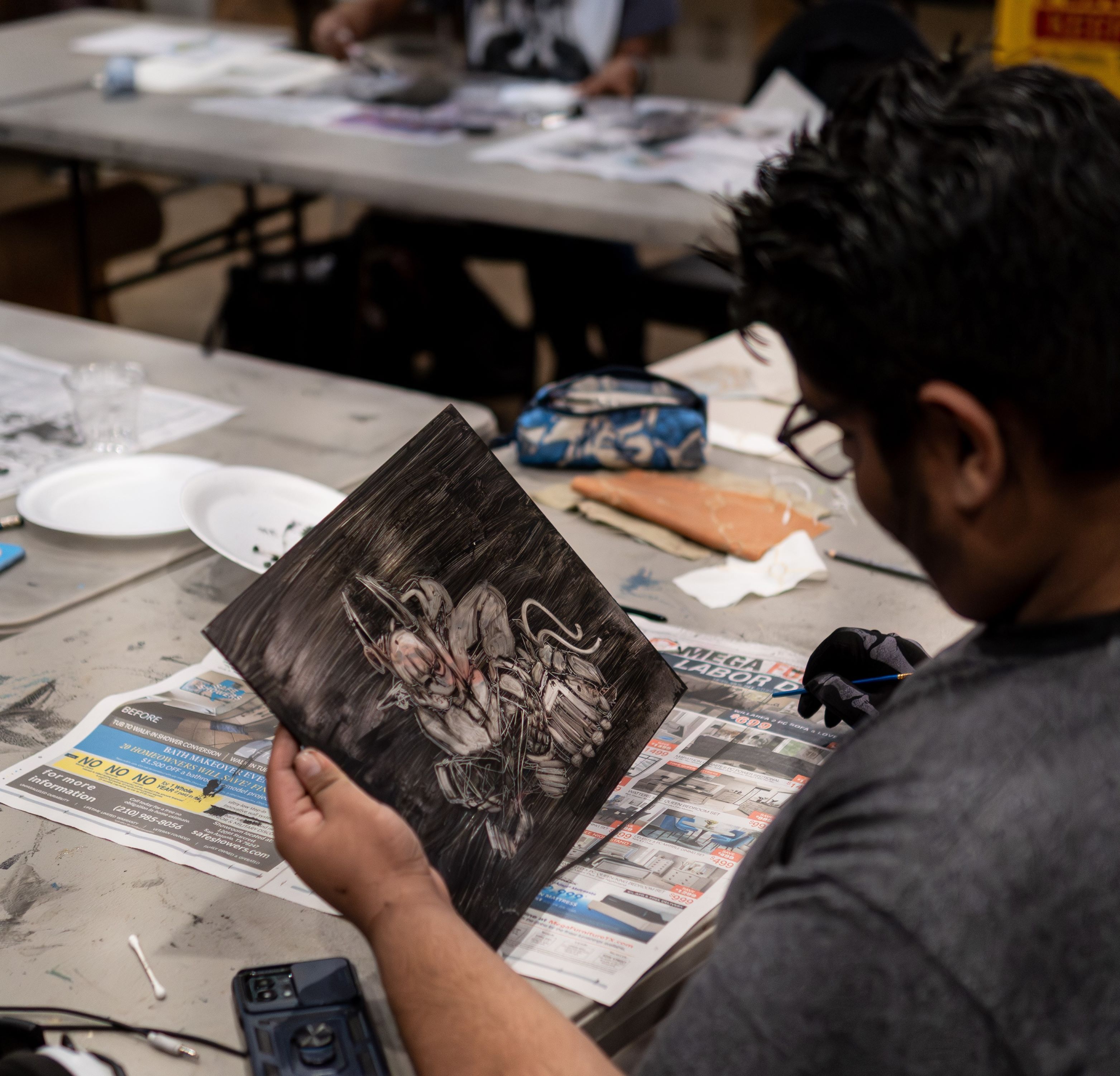 A student is inspecting his printmaking design