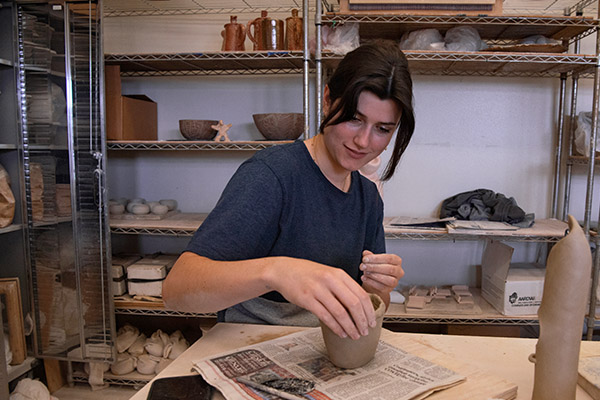 Art student in a ceramics studio working on her ceramics project