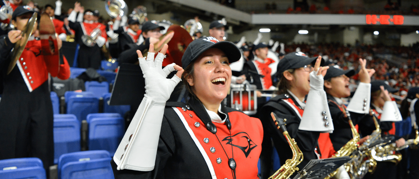 Members of the Marching Cardinals in the stands at a game