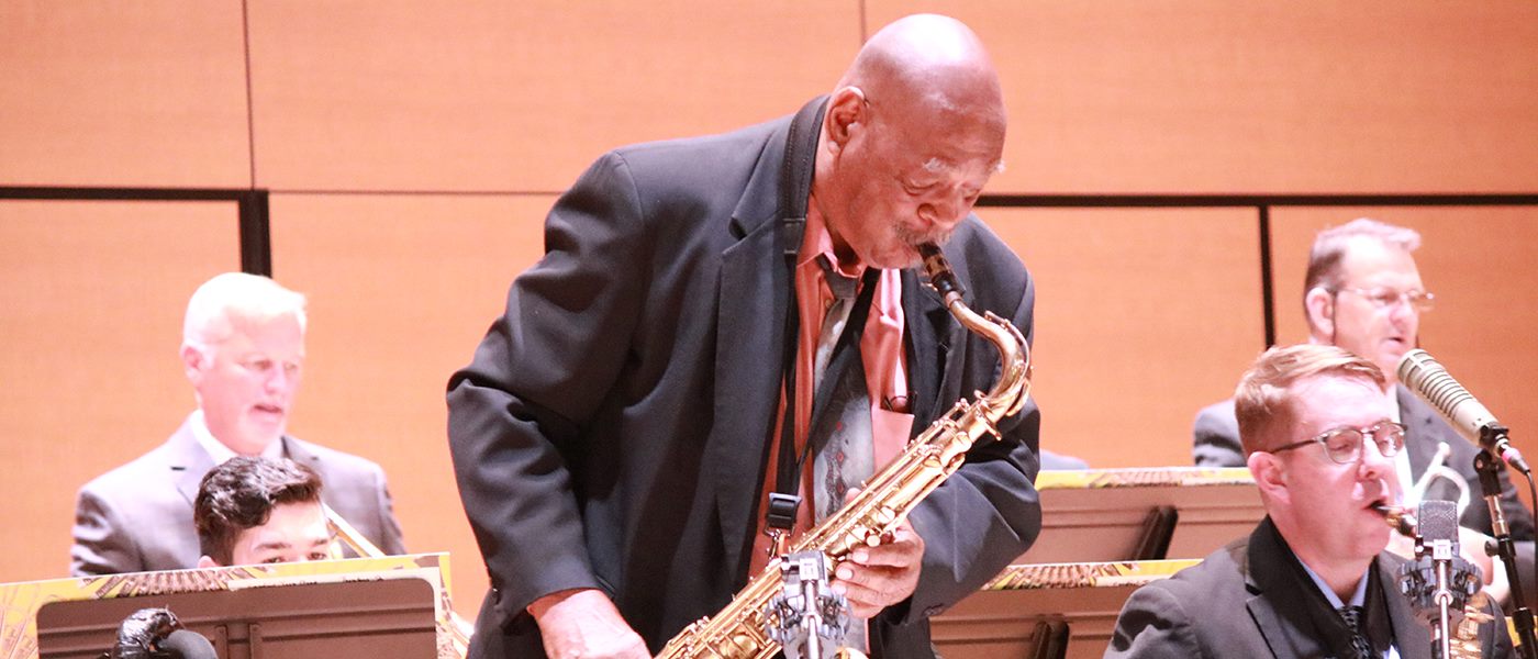 Saxophone soloist playing with jazz band