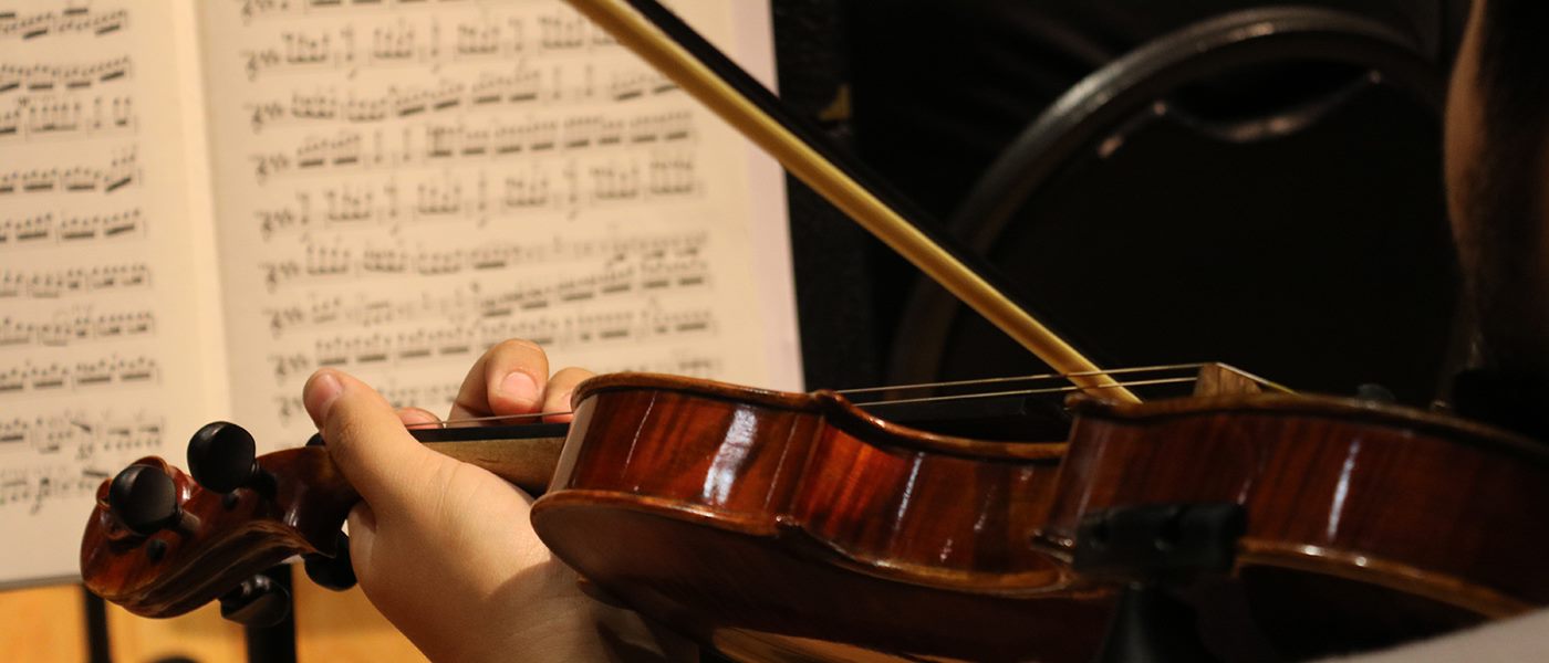 violin player looking at sheet music