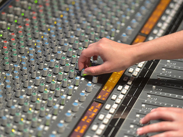 Band member playing the drums inside the studio during a recording session