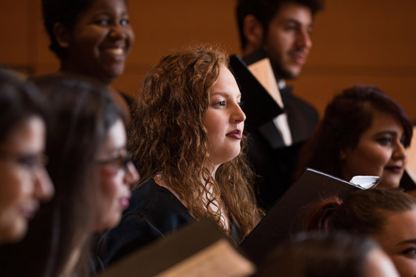 Choir members on stage during a performance