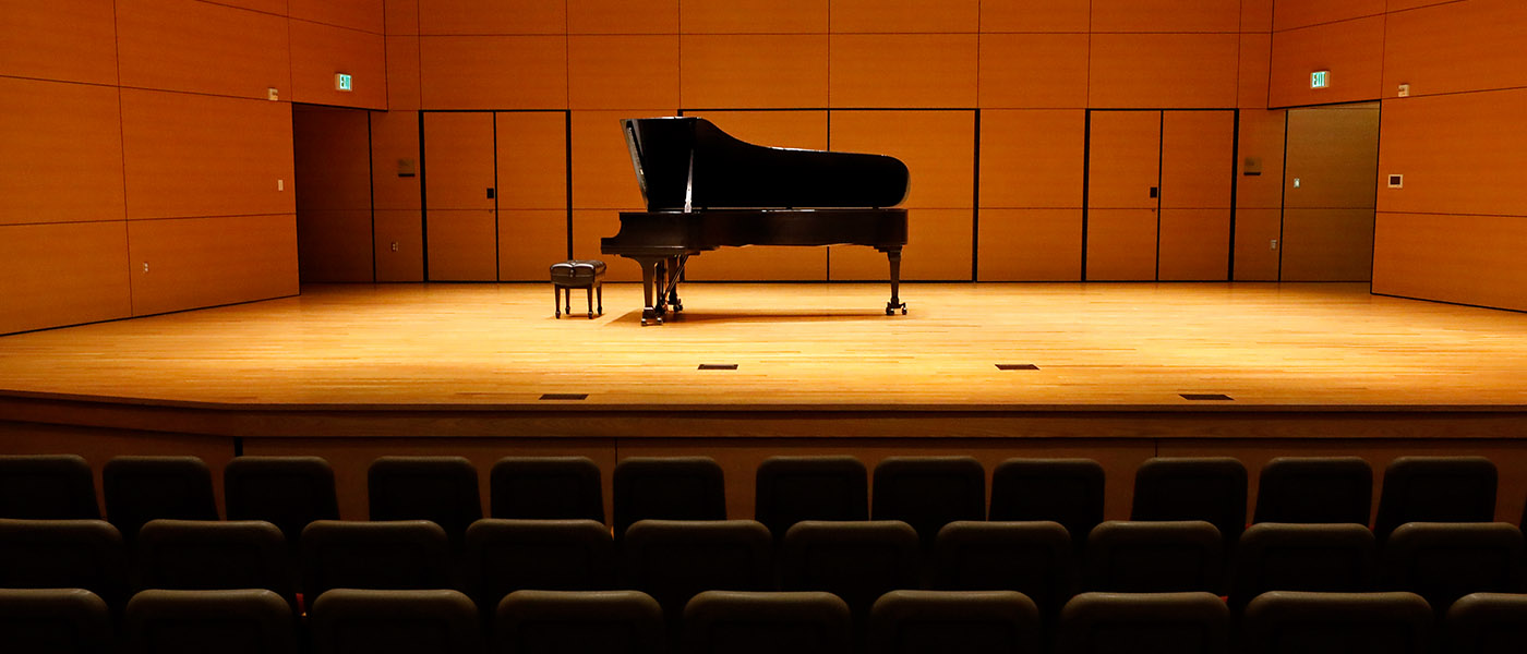 Close up view of a concert piano up on stage