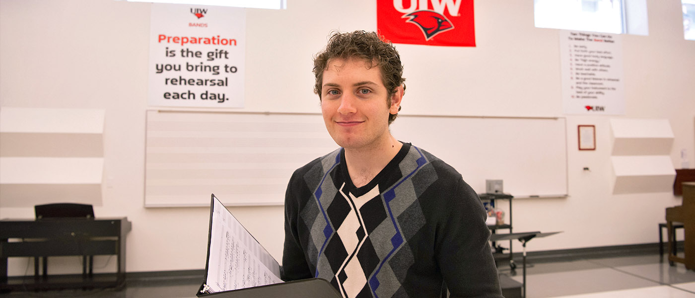 Chorale student in practice room holding a music book