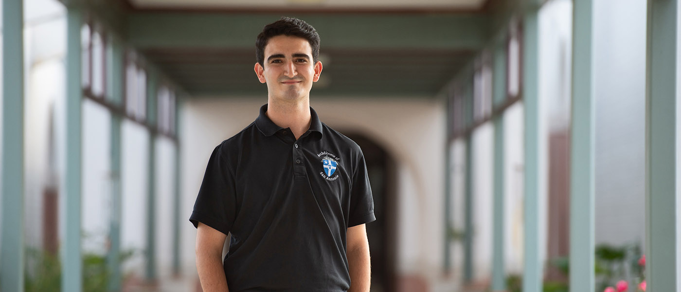 Pastoral Ministry student standing in an outdoor hallway.