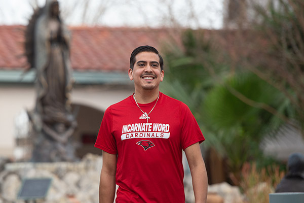 Pastoral Ministry student walking through campus outdoors