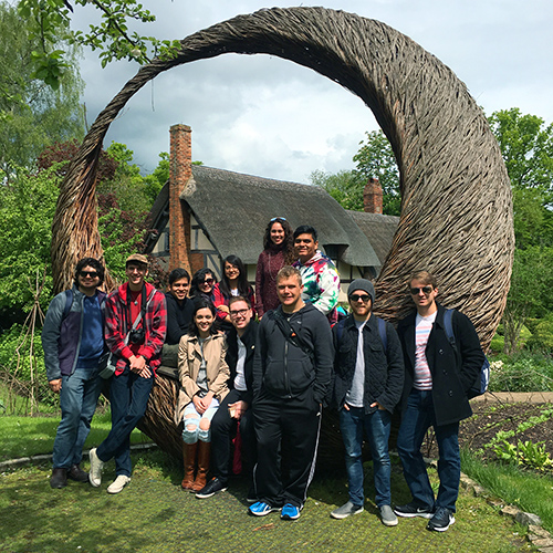 Theatre arts study abroad students in London standing in front of a sculpture