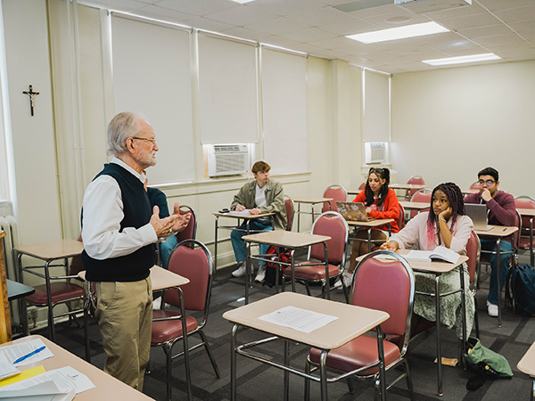 Professor speaking to students in a classroom