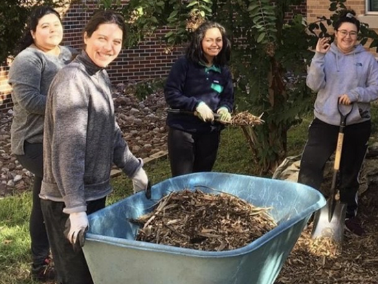 Students doing outdoor community service work on campus