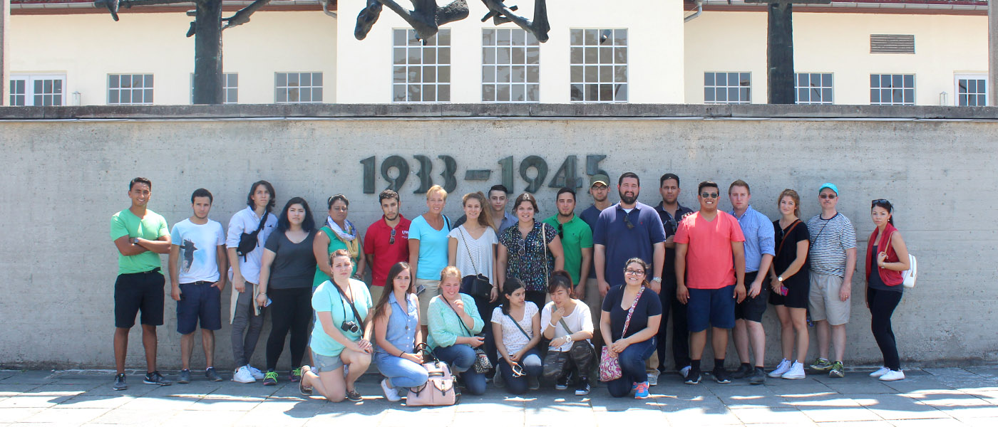 Group photo of political science students on a class trip to the World War 2 memorial in Dachau, Germany