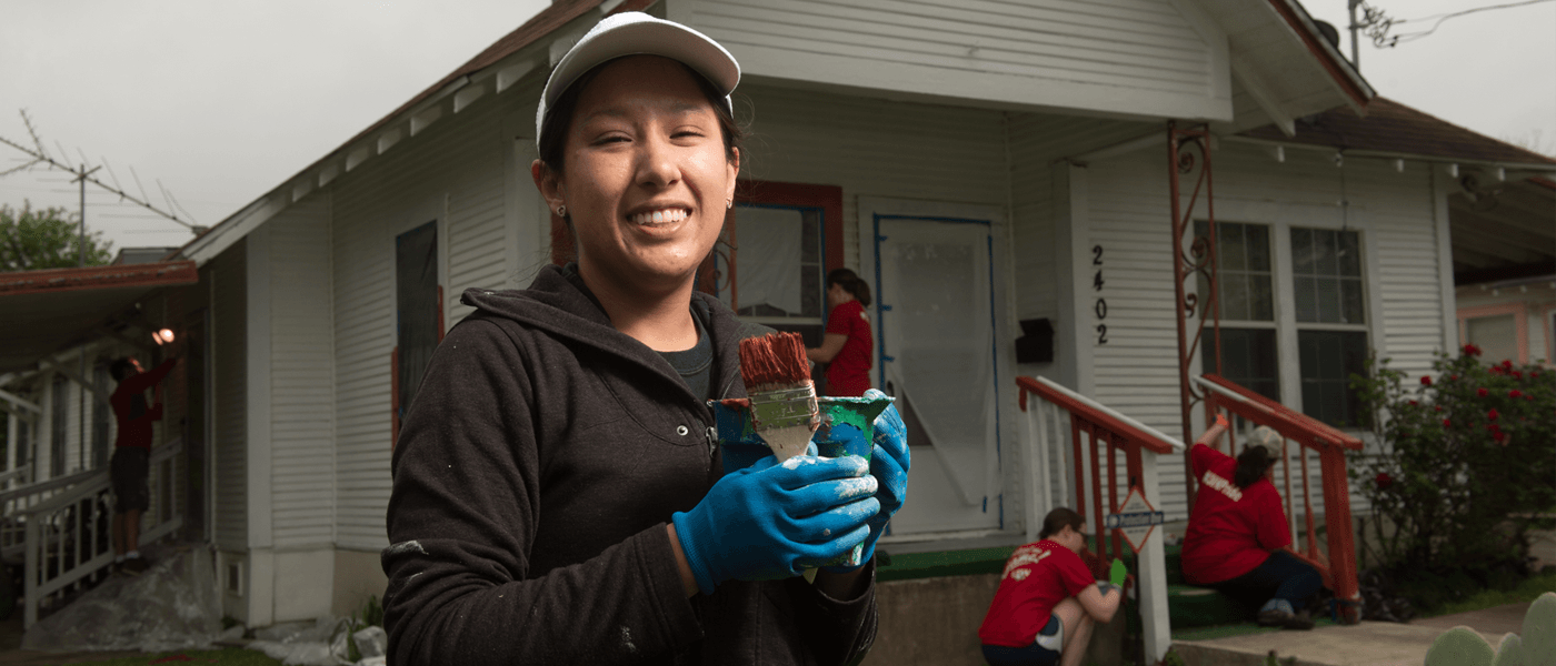 Student holding a paintbrush