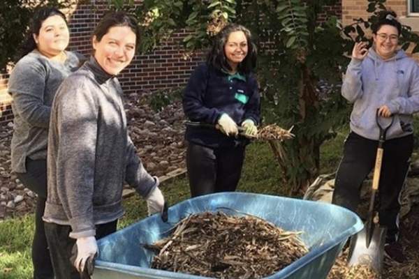 students gathered doing yard work