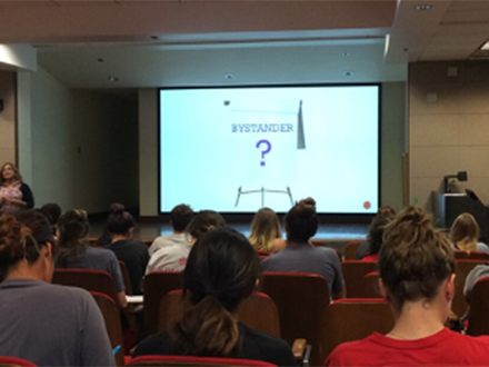 student athletes in an auditorium attending a conference