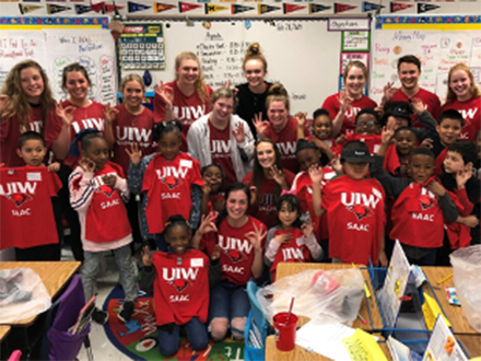 student athletes visiting a grade school classroom