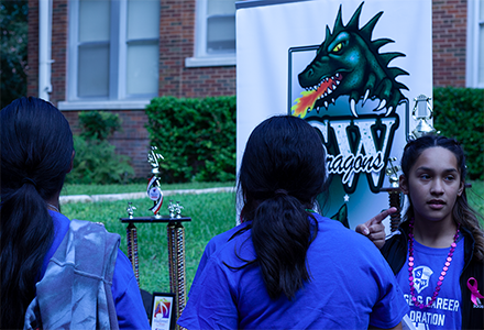 ISD students in front of school banner