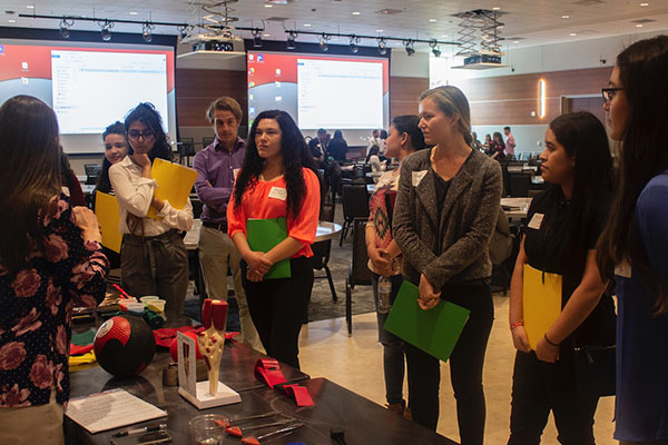 A group of students watching a presentation