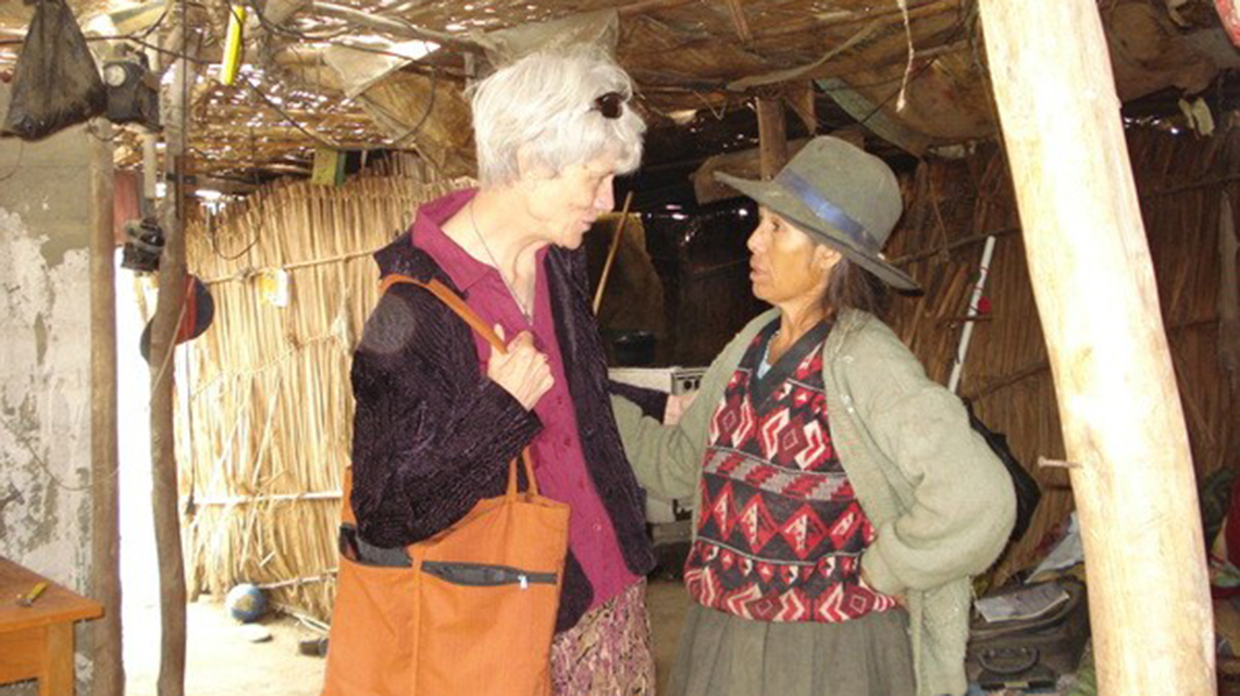 two women standing in a hut