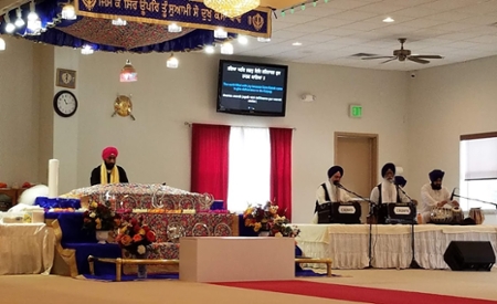 Harvinder Singh, Parminder’s father (on the left) and Amarjeet Singh, her grandfather (third from the left) were leaders in the service of prayer and chanting