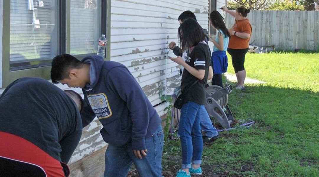 Students painting a house