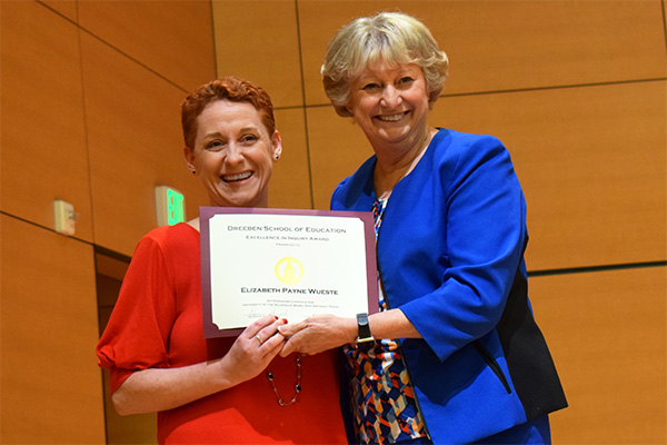 Elizabeth L. Payne and a colleague holding a certificate