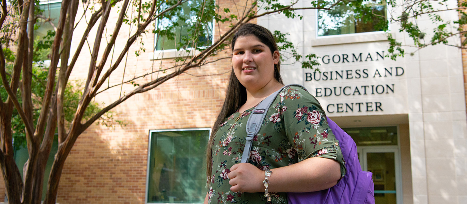 Student in front of Gorman Business and Education Center