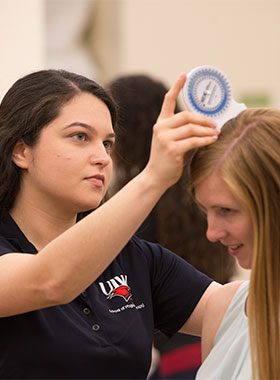 Physical Therapy students interacting with tools