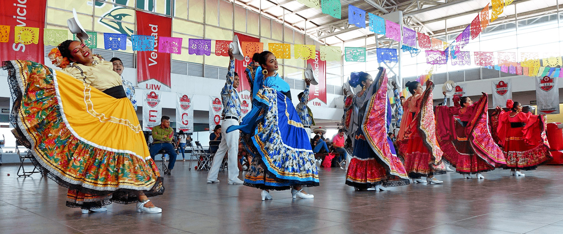 Men and Women performing a traditional Mexican dance on the UIW Bajío campus