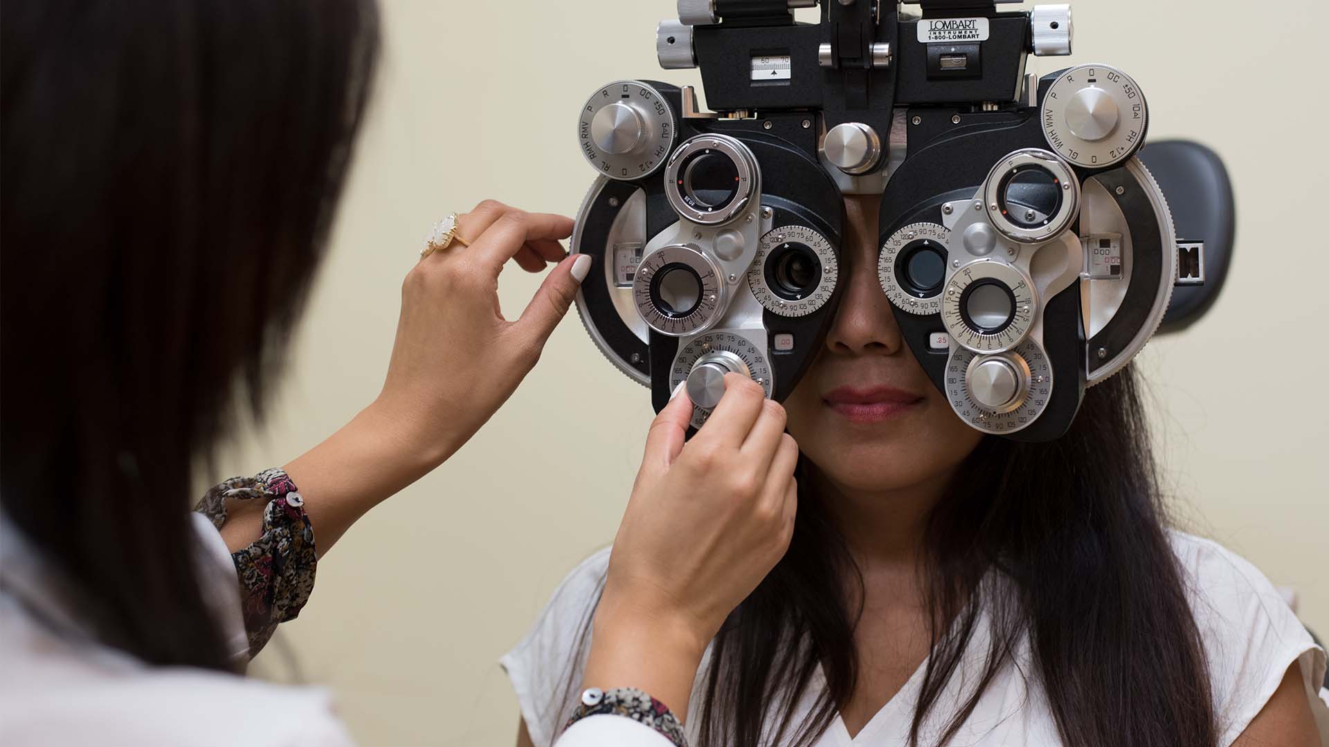 Optometry student examining a patients eyes